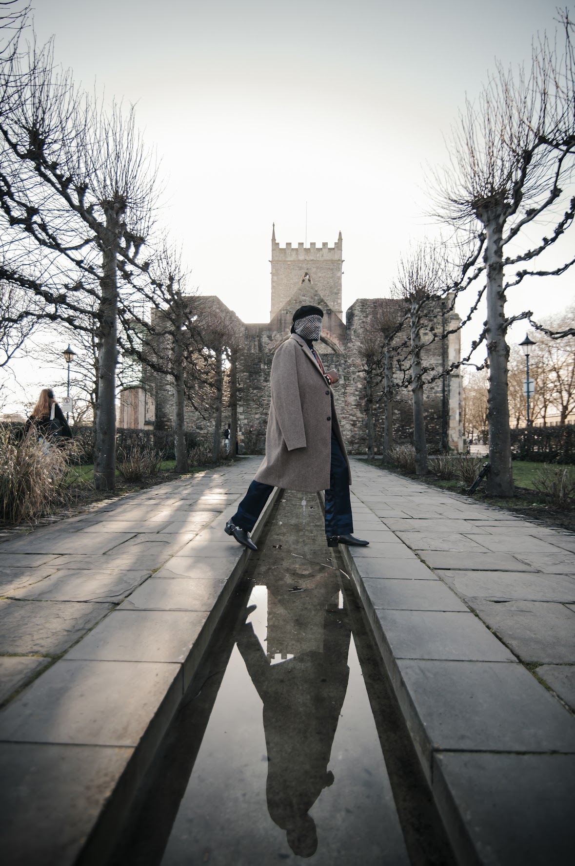 Trepetsi editorial styling with a long coat outside a historic stone church
